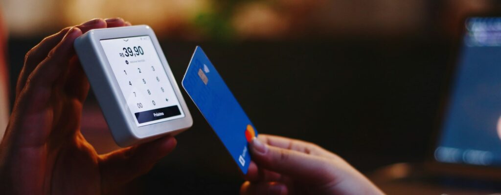 a person holding a credit card and a cell phone